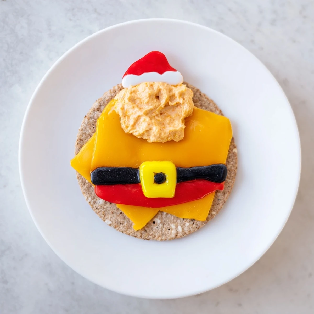 Savory Santa's Belt Crackers & Dip, cheese crackers topped with dip and decorated with olive belts, look delicious!