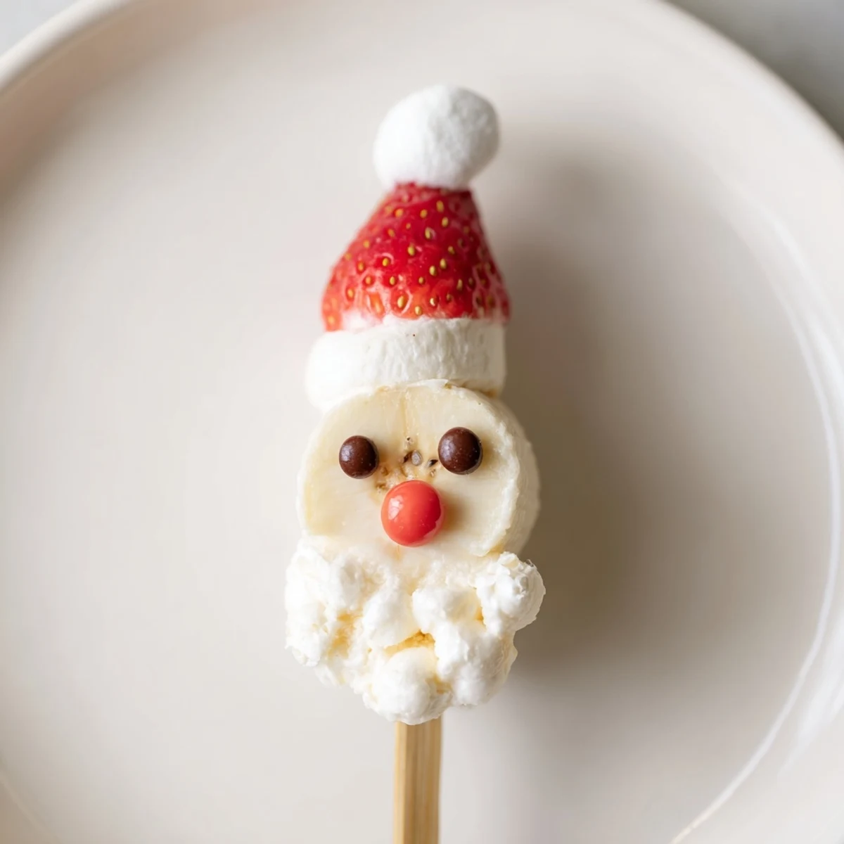 Festive Banana Santa Snack Sticks presented on skewers, a fun and colorful holiday snack option.