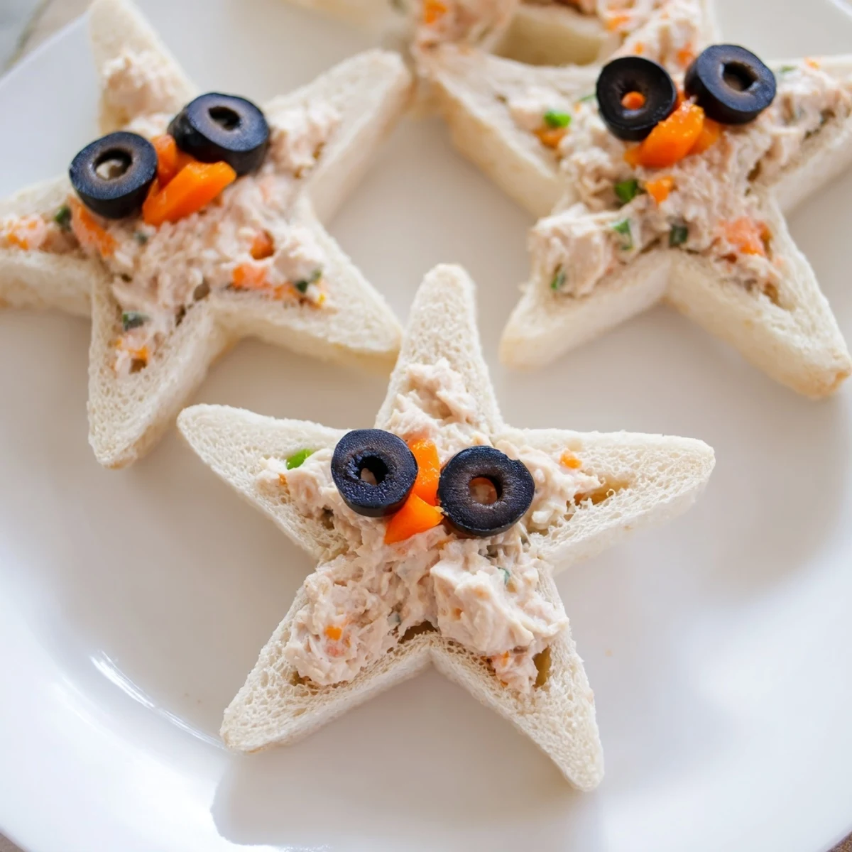 Freshly made Mini Starfish Sandwiches, the perfect appetiser featuring adorable star shapes and savory tuna.
