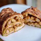 Close-up of fluffy German apple fritter rolls, showcasing the spiced apple filling and glaze.