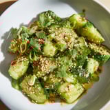 Fresh Chinese Spicy Smashed Cucumber Salad, garnished with sesame seeds, ready to be enjoyed as a refreshing side dish.