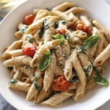 A close-up of delicious Cottage Cheese High-Protein Creamy Pasta, ready to serve with Parmesan.
