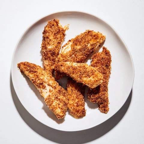 Golden, crispy air-fried chicken tenders, a healthier take on classic American comfort food.