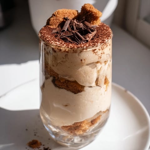 A creamy Tiramisu Latte topped with cocoa, a decadent coffee dessert.