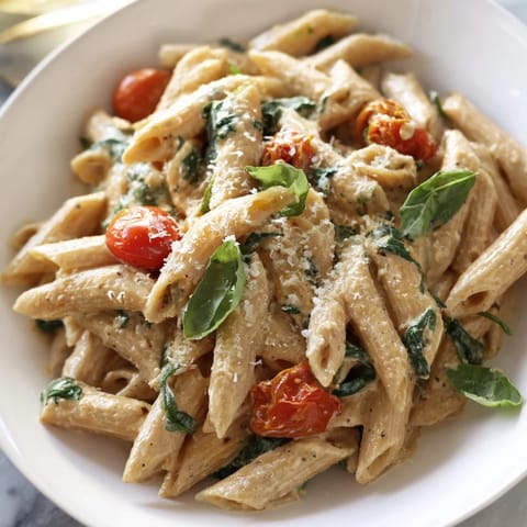 A close-up of delicious Cottage Cheese High-Protein Creamy Pasta, ready to serve with Parmesan.