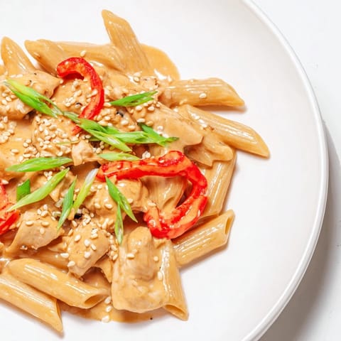 Garnished with green onions and sesame seeds, this Sweet Chili Chicken Pasta offers a vibrant fusion of Asian and Italian flavors for dinner.