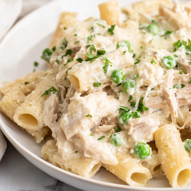 Delicious Slow Cooker Chicken Alfredo Pasta Bake, served hot and garnished with fresh parsley.